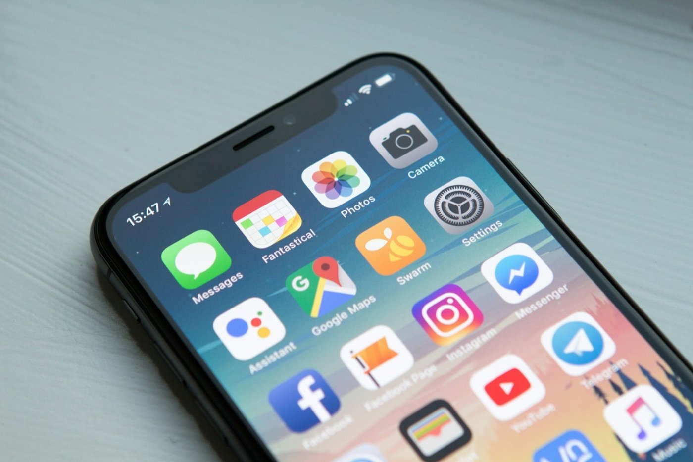 A smartphone showing a home screen full of apps